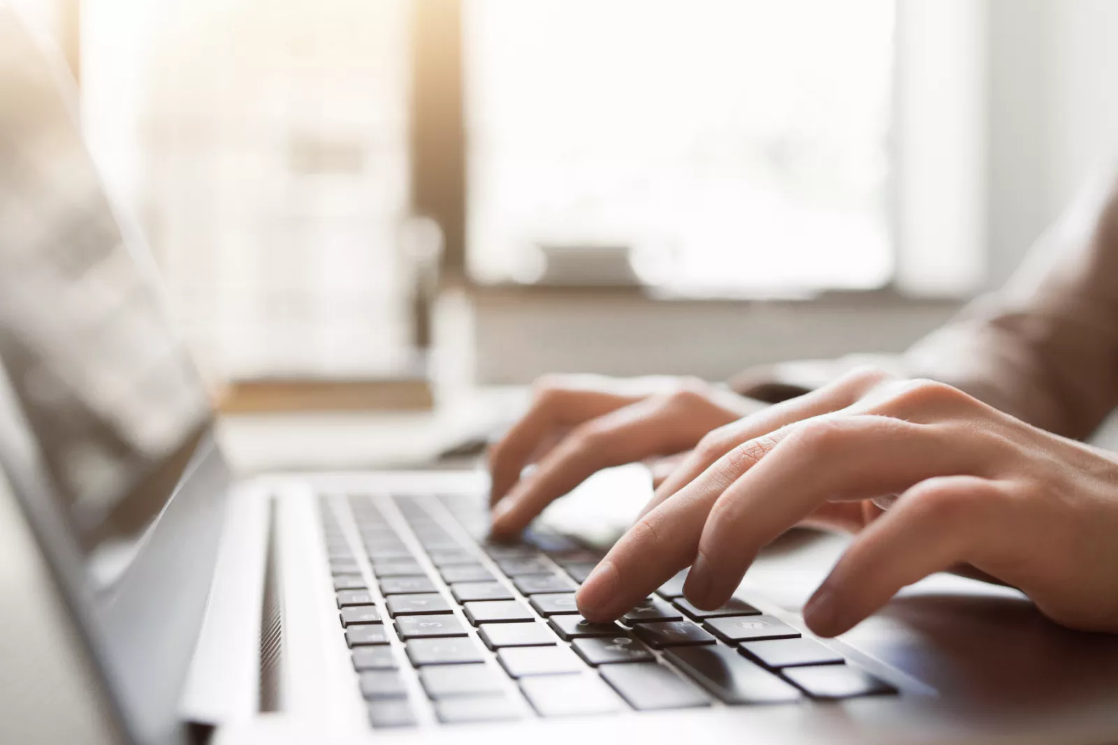 person typing on a laptop