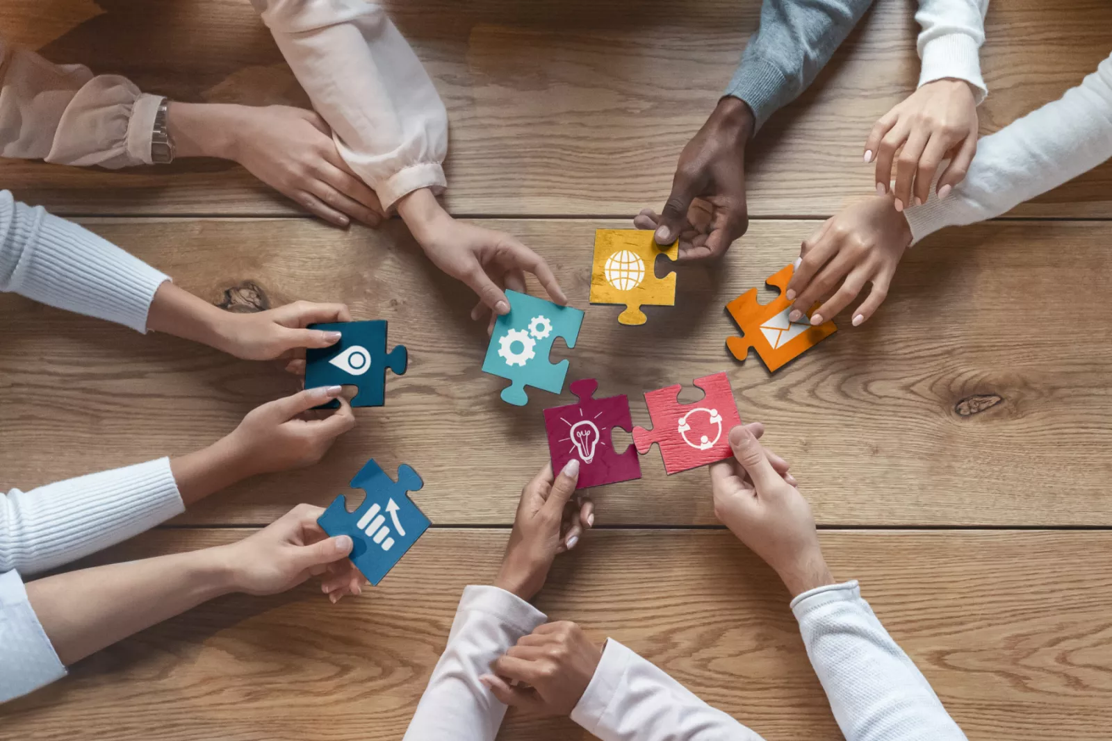 a team holding service puzzle pieces
